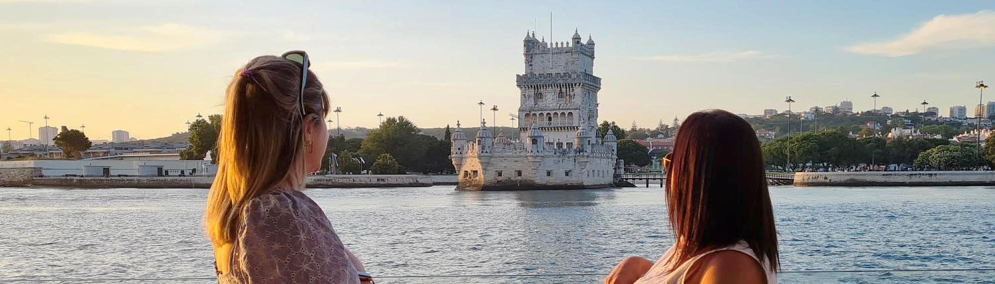 Two woman on the FRS Portugal Sunset Cruise in Lisbon looking at the sights