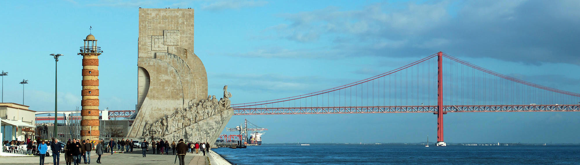 View of the bridge 25 de Abril, the Monument of the Discoveries and the Belem Lighthouse from the promenade.