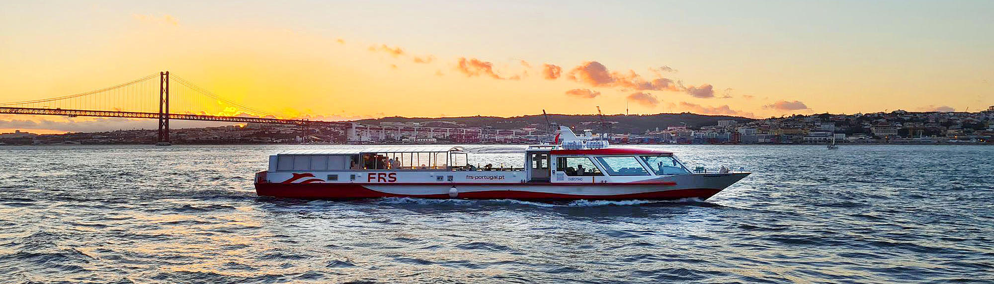 Ferry vessel on the Tagus River at sunset.