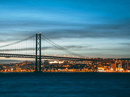 View of Lisbon's waterfront in the evening glow from the water.