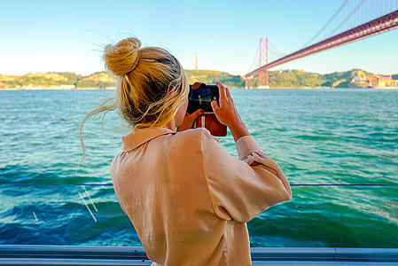FRS Portugal Day Cruise - Woman on a boat does a photo 