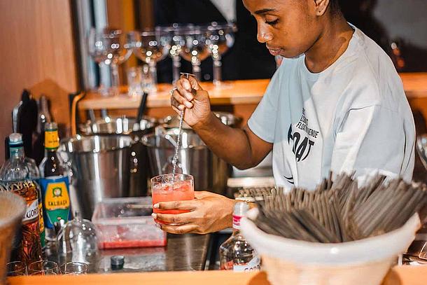 Crew at onboard bar mixing a cocktail at Love Float - Lisboa Boat Party