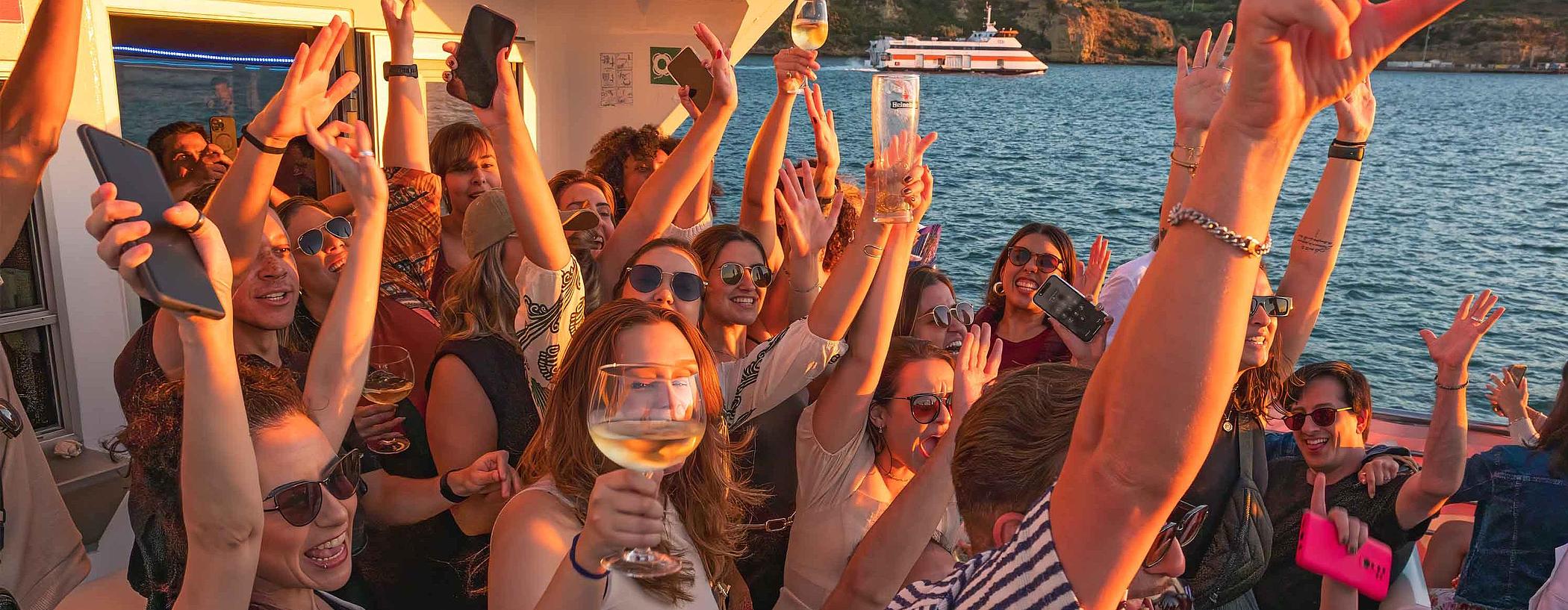 arty crowd on the outdoor deck at sunset at the Lisbon Float Party