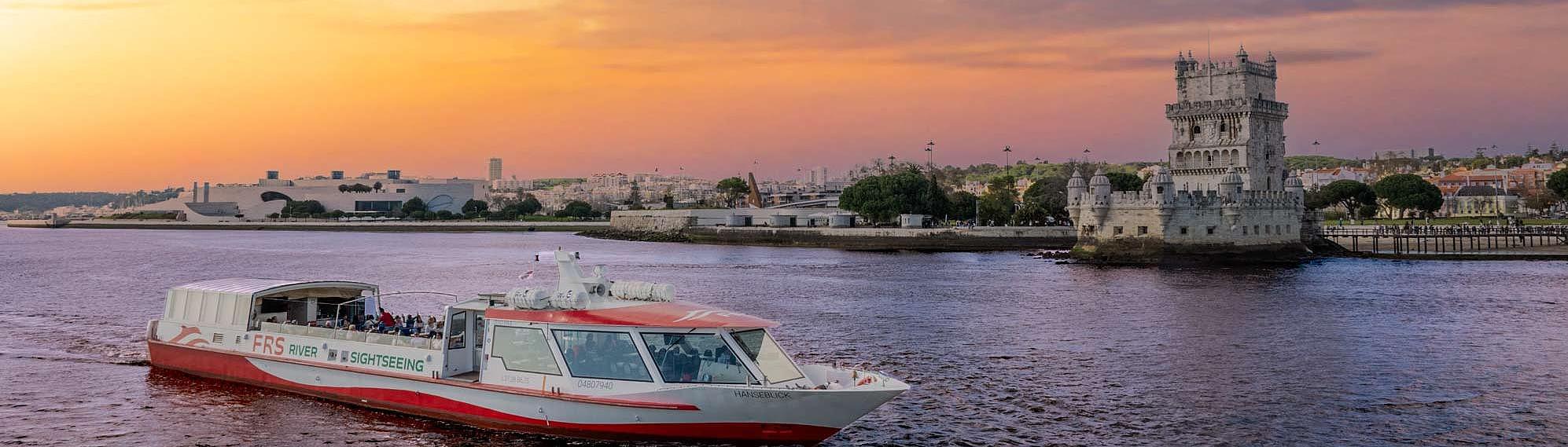MS Hanseblick cruises at sunset in front of the iconic Belém Tower.