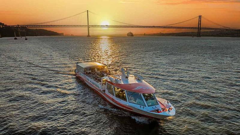 MS 'Hanseblick' in front of the bridge Ponte 25 de Abril on the Tagus River at sunset.