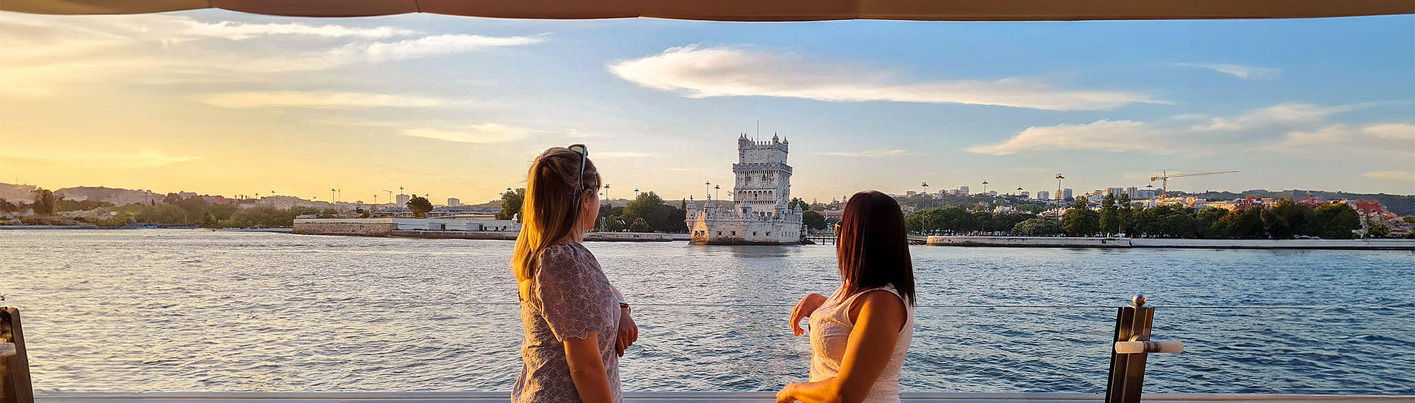 Two people on the FRS Portugal Sunset Cruise in Lisbon looking at the sights