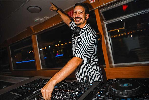 DJ Mojo turning the DJ console at Love Float - Lisboa Boat Party