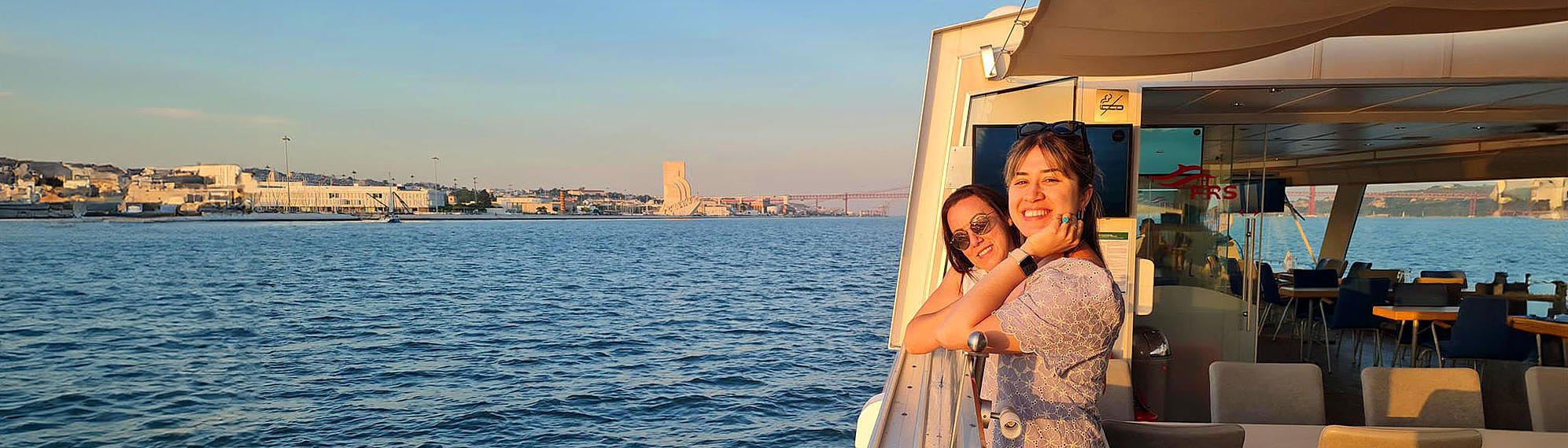  Two woman enjoying the frs portugal sunset cruise on the tagus river